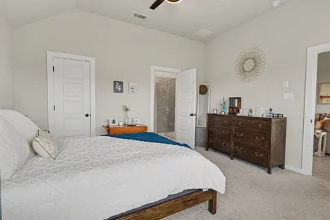 a bedroom with a bed and a dresser