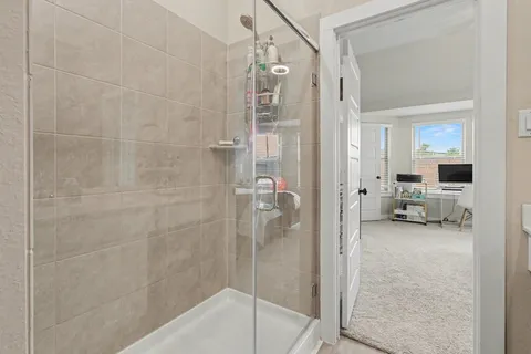 a bathroom with a glass shower door