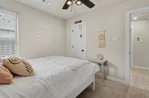 a bedroom with a bed and a chandelier