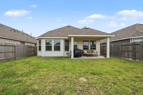 a view of a house with backyard porch and garden