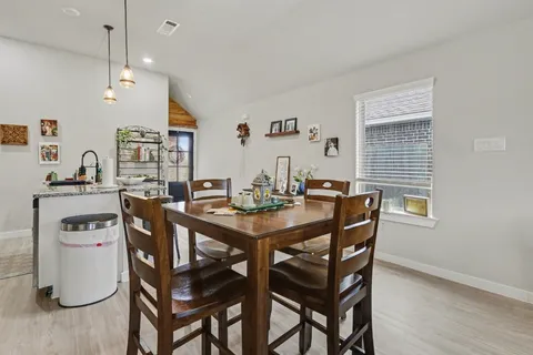 a dining room with a wooden table and chairs