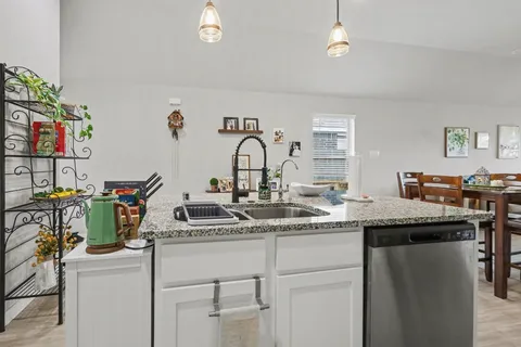 a kitchen with a sink and cabinets