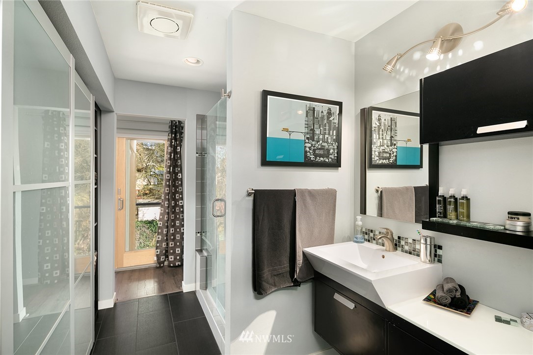 342 Northwest 48th Street Seattle, WA 98107 - Photo 14 of 20 a bathroom with a sink a large mirror and a shower
