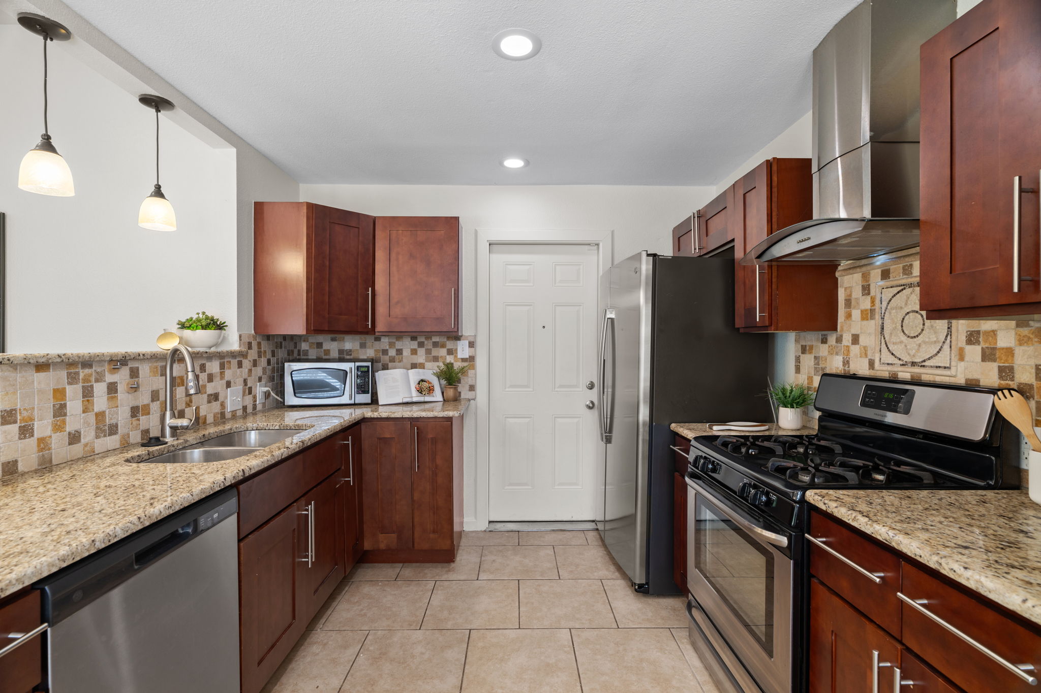 2604 Cockburn Drive Austin, TX 78745 - Photo 29 of 34 The kitchen keeps the conversation flowing with a layout that connects cooking, dining, and living.