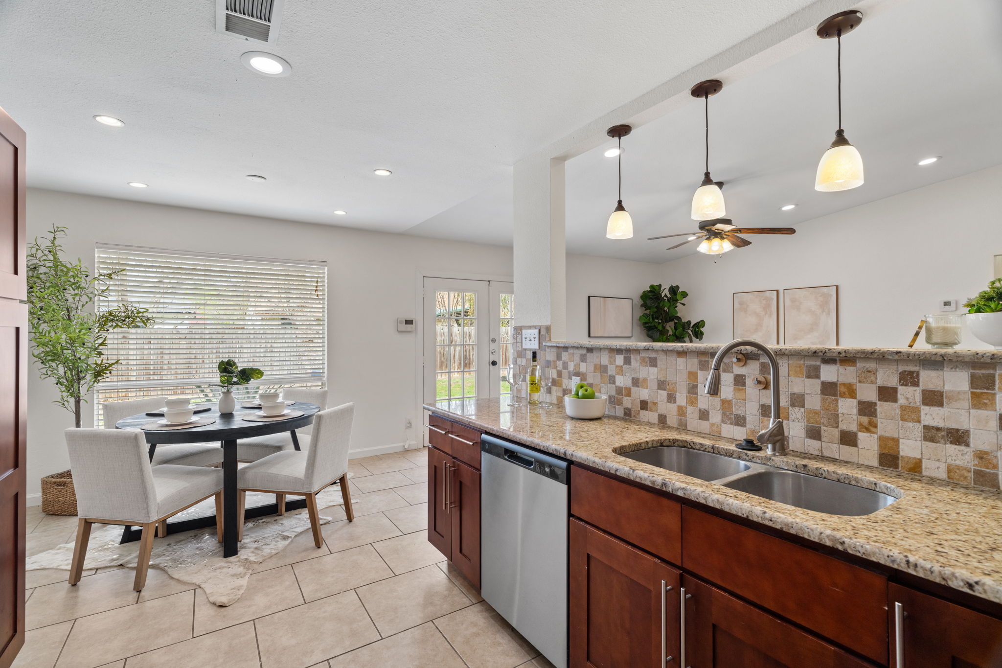 2604 Cockburn Drive Austin, TX 78745 - Photo 3 of 34 The kitchen overlooks the living area so hosts never miss the fun.