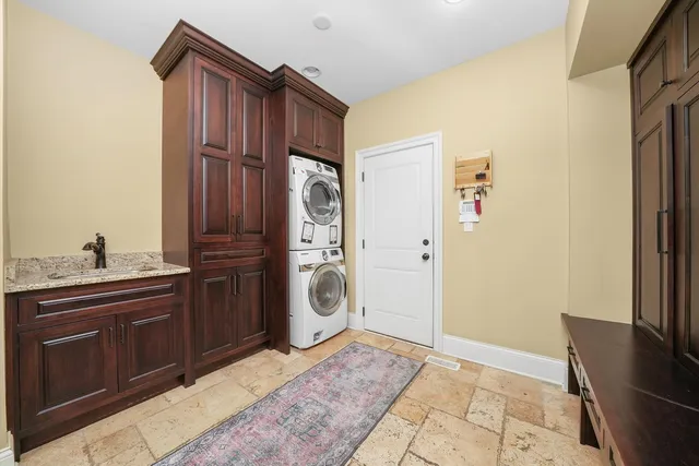a living room with furniture a chandelier and a flat screen tv