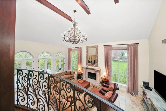 a spacious bedroom with a bed and a chandelier