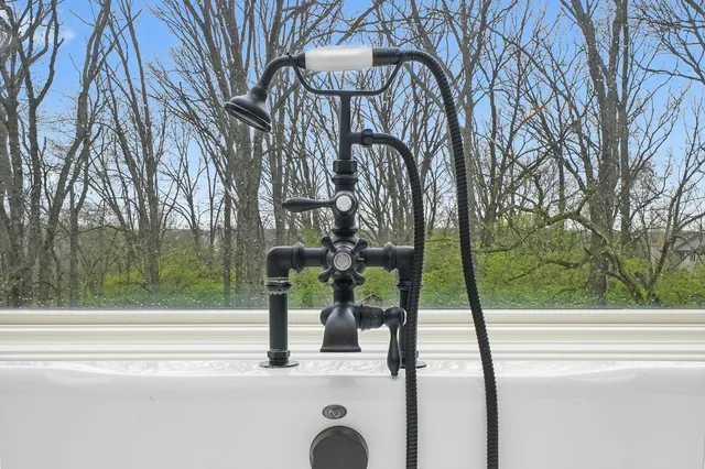 a living room with a large window and a table