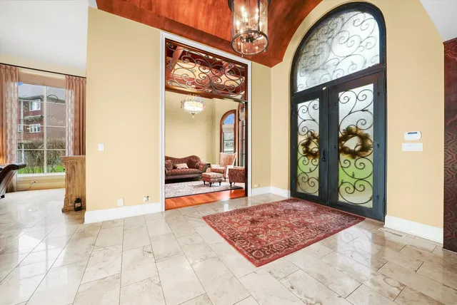 a view of a hallway with a dining table and a chandelier