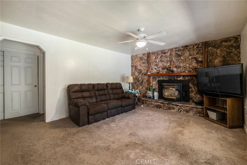 5048 Big Bend Road Oroville, CA 95965 - Photo 13 of 75 a living room with furniture a flat screen tv and a fireplace