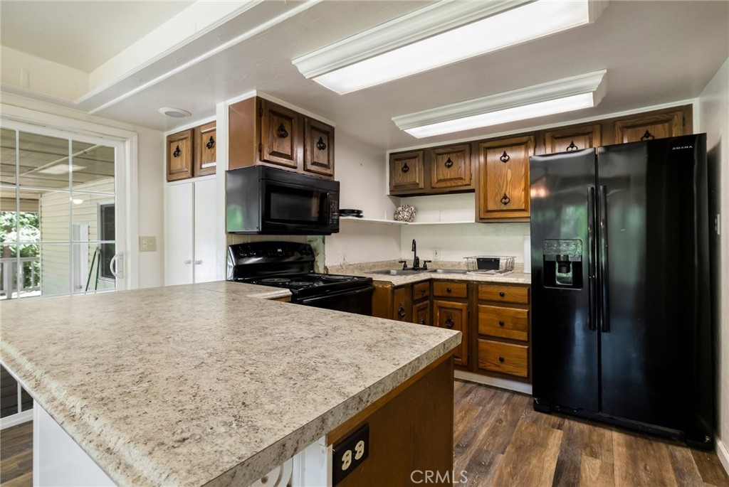 5048 Big Bend Road Oroville, CA 95965 - Photo 18 of 75 a kitchen with stainless steel appliances granite countertop a refrigerator a stove top oven a sink and dishwasher