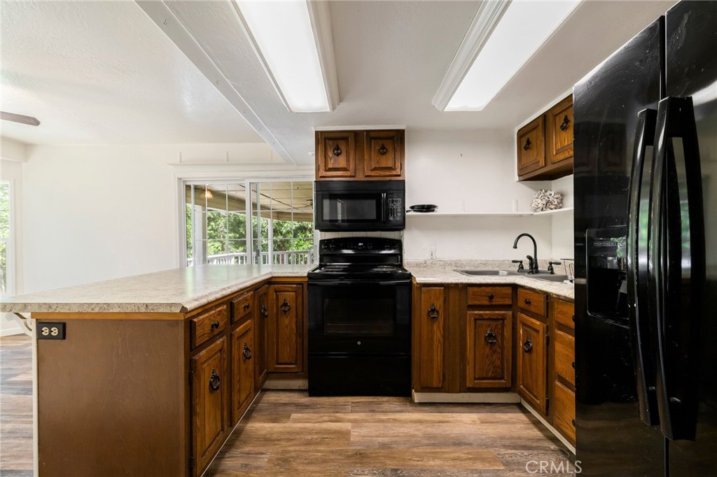 5048 Big Bend Road Oroville, CA 95965 - Photo 19 of 75 a kitchen with stainless steel appliances granite countertop a stove top oven a sink and dishwasher