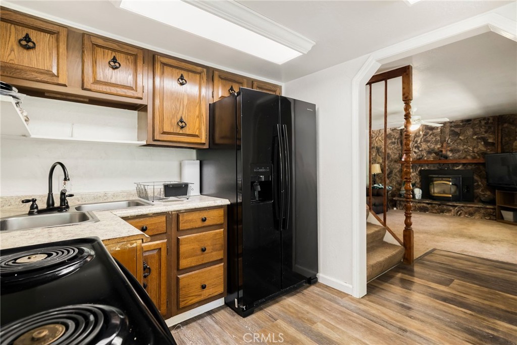 5048 Big Bend Road Oroville, CA 95965 - Photo 21 of 75 a kitchen with stainless steel appliances granite countertop a refrigerator and a stove top oven