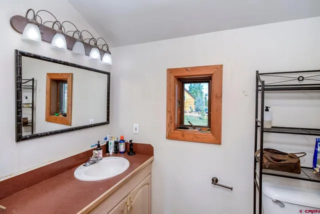 a bathroom with a sink vanity and a mirror