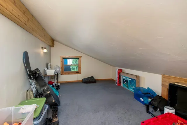 a living room with furniture gym equipment and a flat screen tv