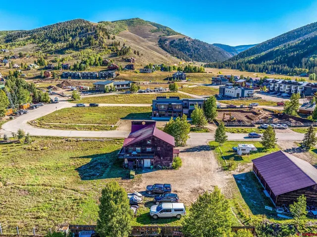 an aerial view of residential houses with outdoor space