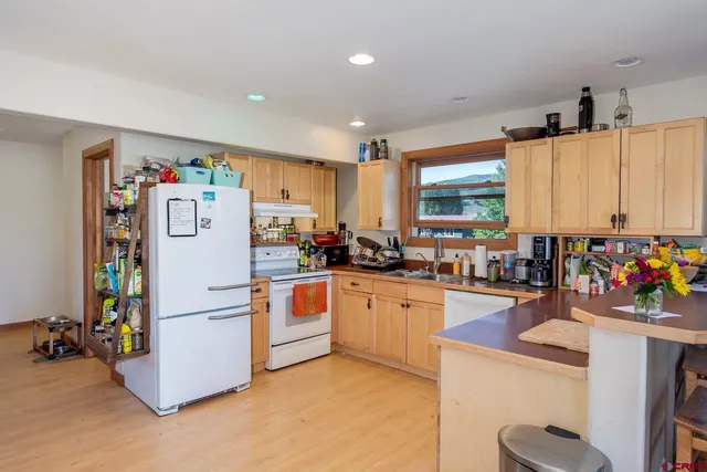 a kitchen with a refrigerator and a sink