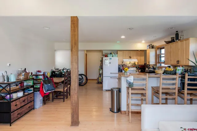 a view of a living room kitchen and entry way