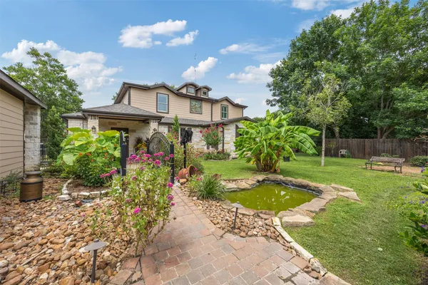 a view of a house with swimming pool and garden