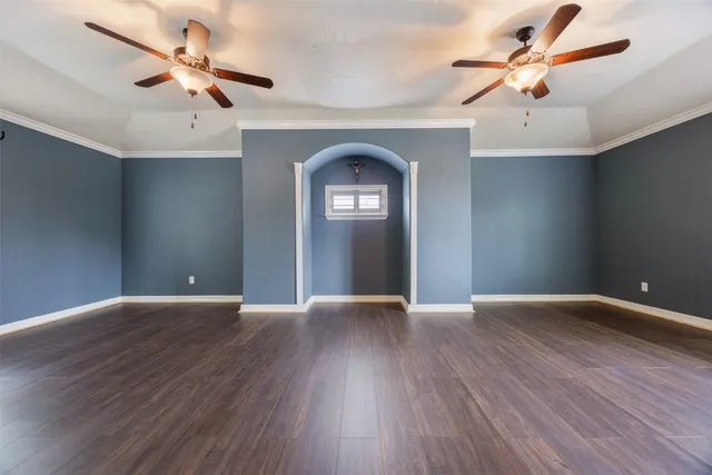 a view of a livingroom with wooden floor and a ceiling fan