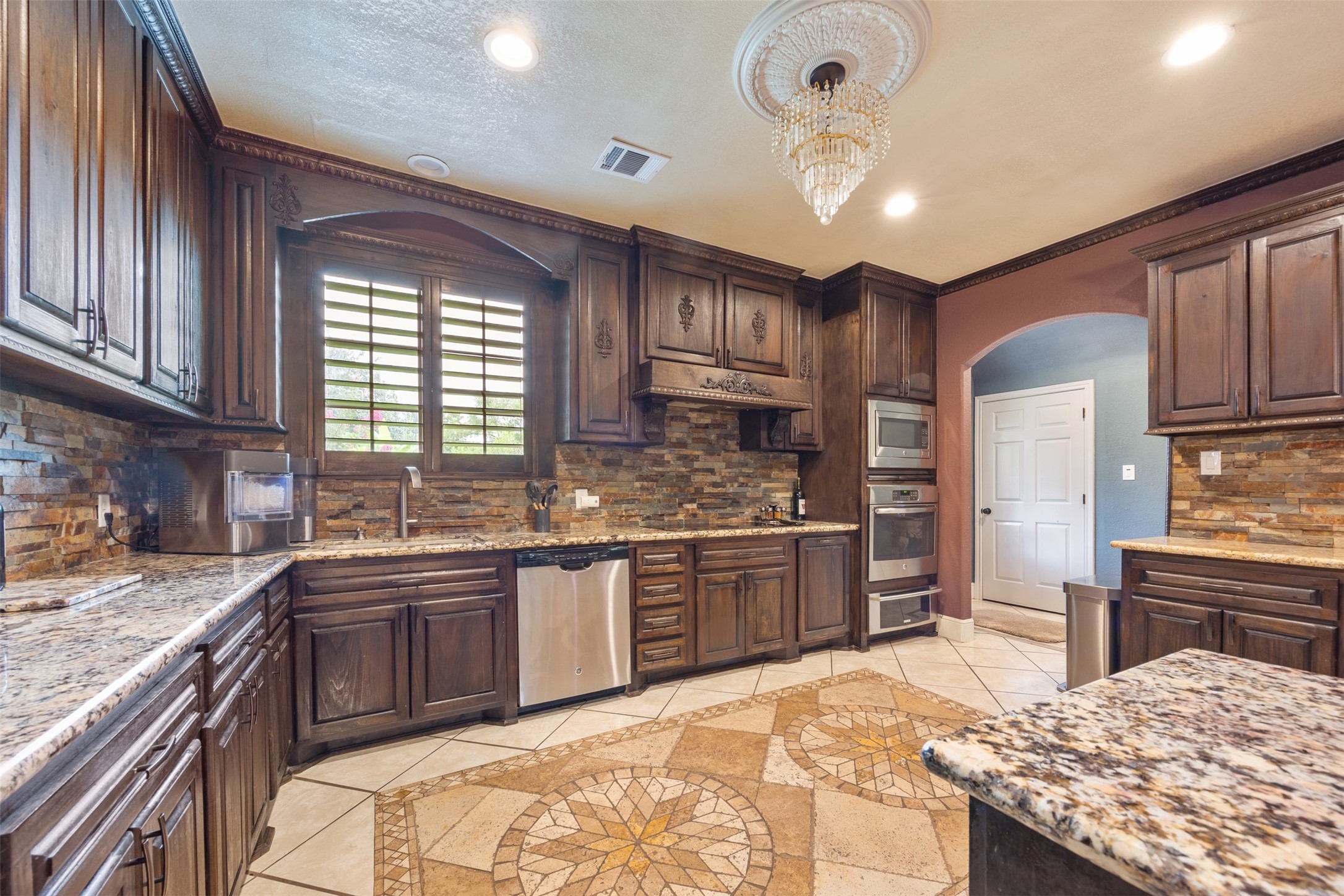 2622 Muegge Road Rosenberg, TX 77471 - Photo 6 of 28 a kitchen with stainless steel appliances granite countertop a sink stove and refrigerator