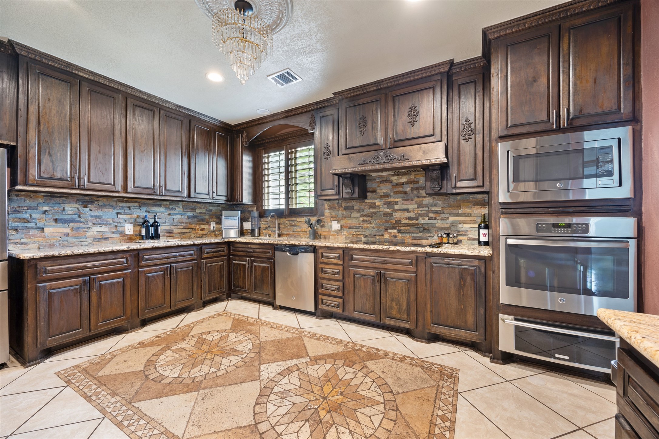 2622 Muegge Road Rosenberg, TX 77471 - Photo 8 of 28 a kitchen with stainless steel appliances granite countertop wooden cabinets a stove top oven a sink and dishwasher