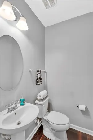 a white toilet sitting next to a bathroom sink