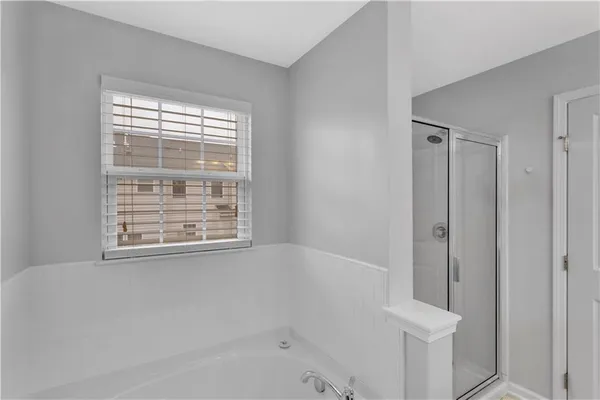 a bathroom with a bathtub and shower