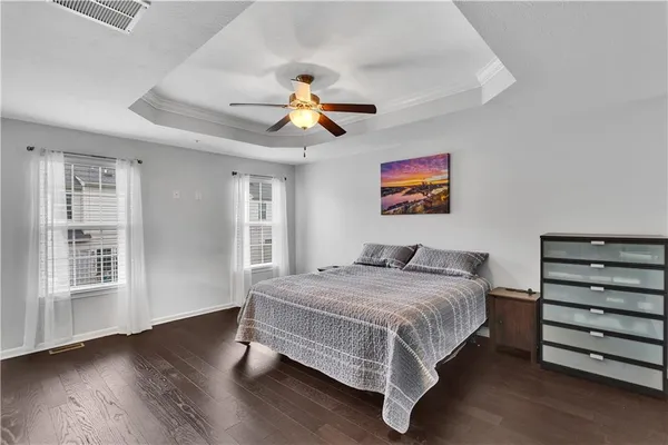 a bedroom with a bed and a painting on the wall