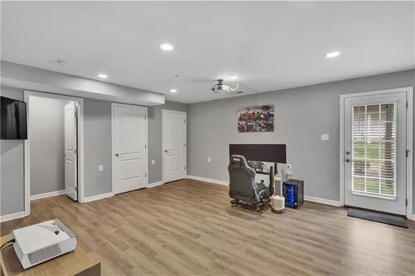 a view of an empty room with furniture and a window