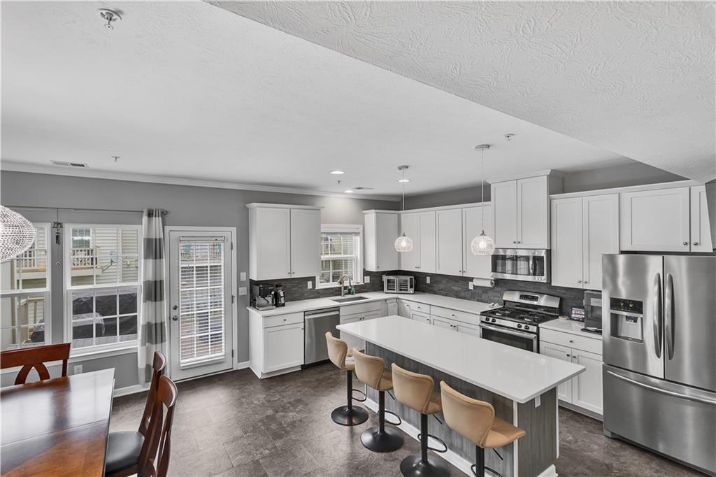 1304 Pointe View Drive Mars, PA 16046 - Photo 3 of 29 a kitchen with white cabinets and stainless steel appliances