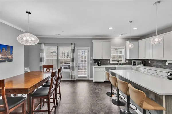 a large kitchen with a table and chairs