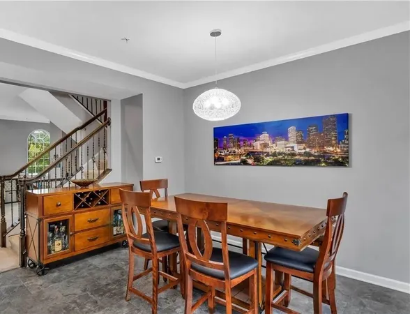a dining room with furniture and a flat screen tv
