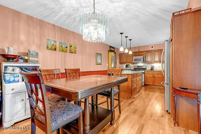 a dining table with chairs and wooden floor