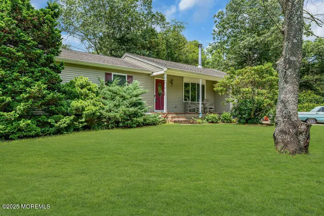 a front view of house with a garden