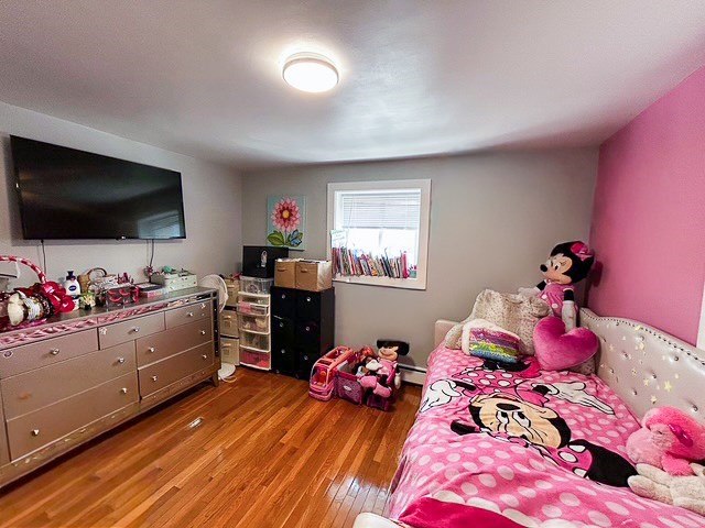 42 Bryon Road, Unit 6 Boston, MA 02467 - Photo 11 of 16 a bedroom with a bed and flat screen tv