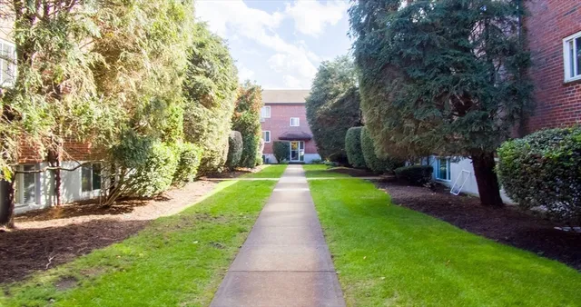 a view of a brick house with a yard