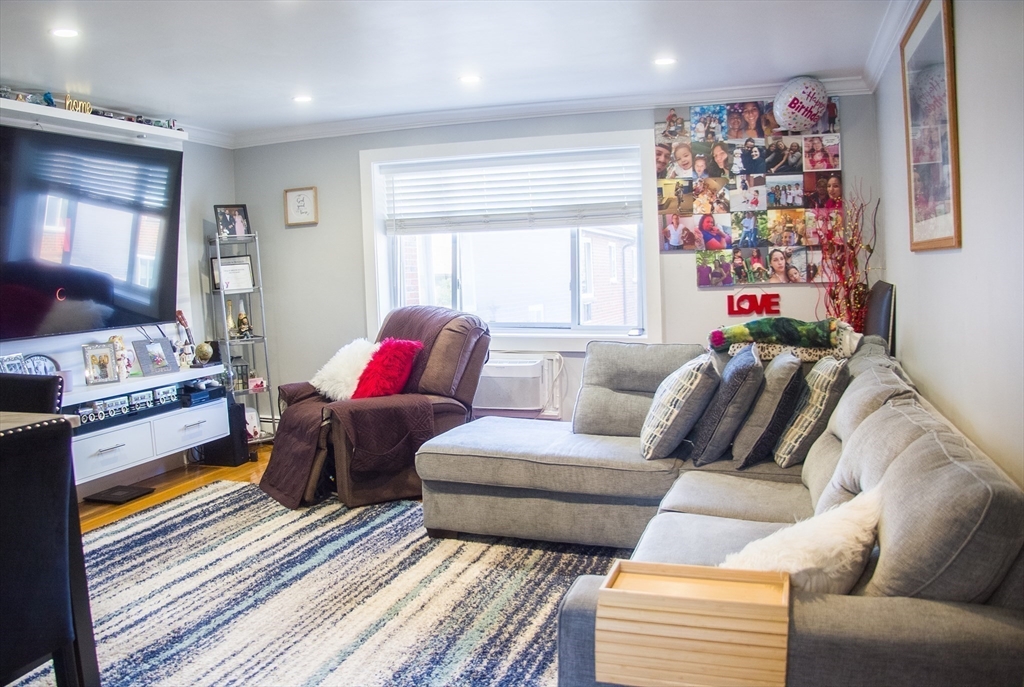 42 Bryon Road, Unit 6 Boston, MA 02467 - Photo 5 of 16 a living room with furniture and a couch