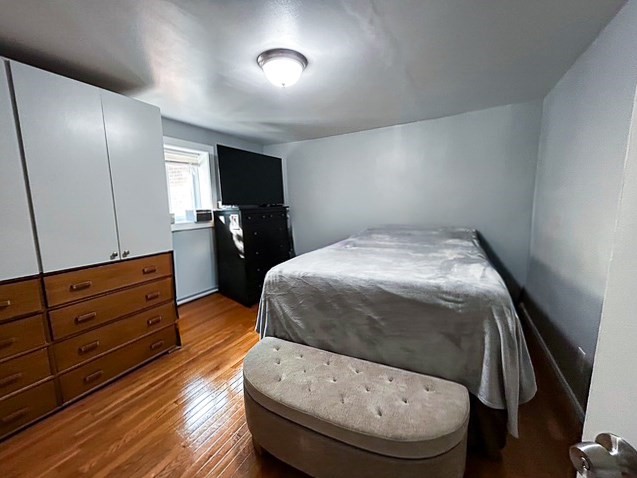 42 Bryon Road, Unit 6 Boston, MA 02467 - Photo 8 of 16 a room with a bed window and furniture