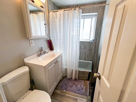 42 Bryon Road, Unit 6 Boston, MA 02467 - Photo 10 of 16 a bathroom with a sink toilet and window