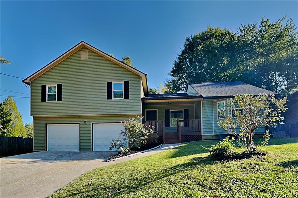 a front view of a house with a yard and garage