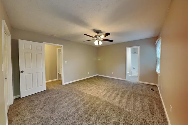 a view of an empty room with a ceiling fan