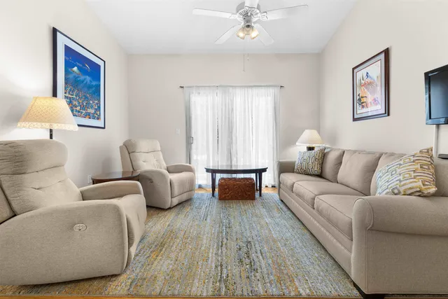 a living room with furniture and a lamp