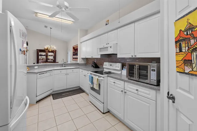 a kitchen with stainless steel appliances granite countertop a sink and cabinets