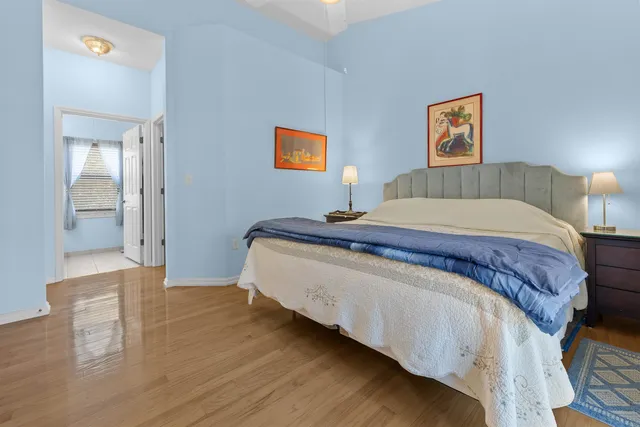 a bedroom with a bed and painting on the wall