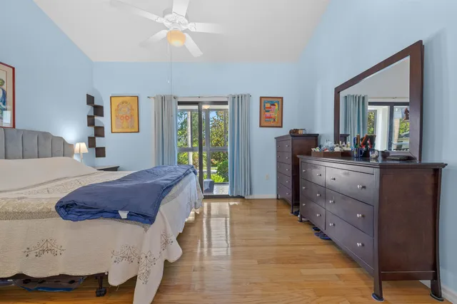 a spacious bedroom with a bed and a dresser