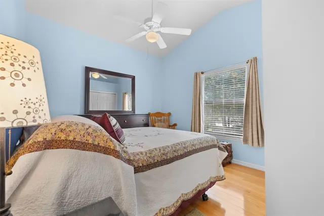 a bedroom with a large bed and a chandelier