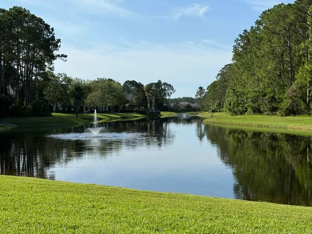 a view of a lake with houses in background
