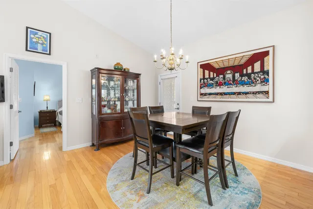 a view of a dining room with furniture wooden floor and a chandelier