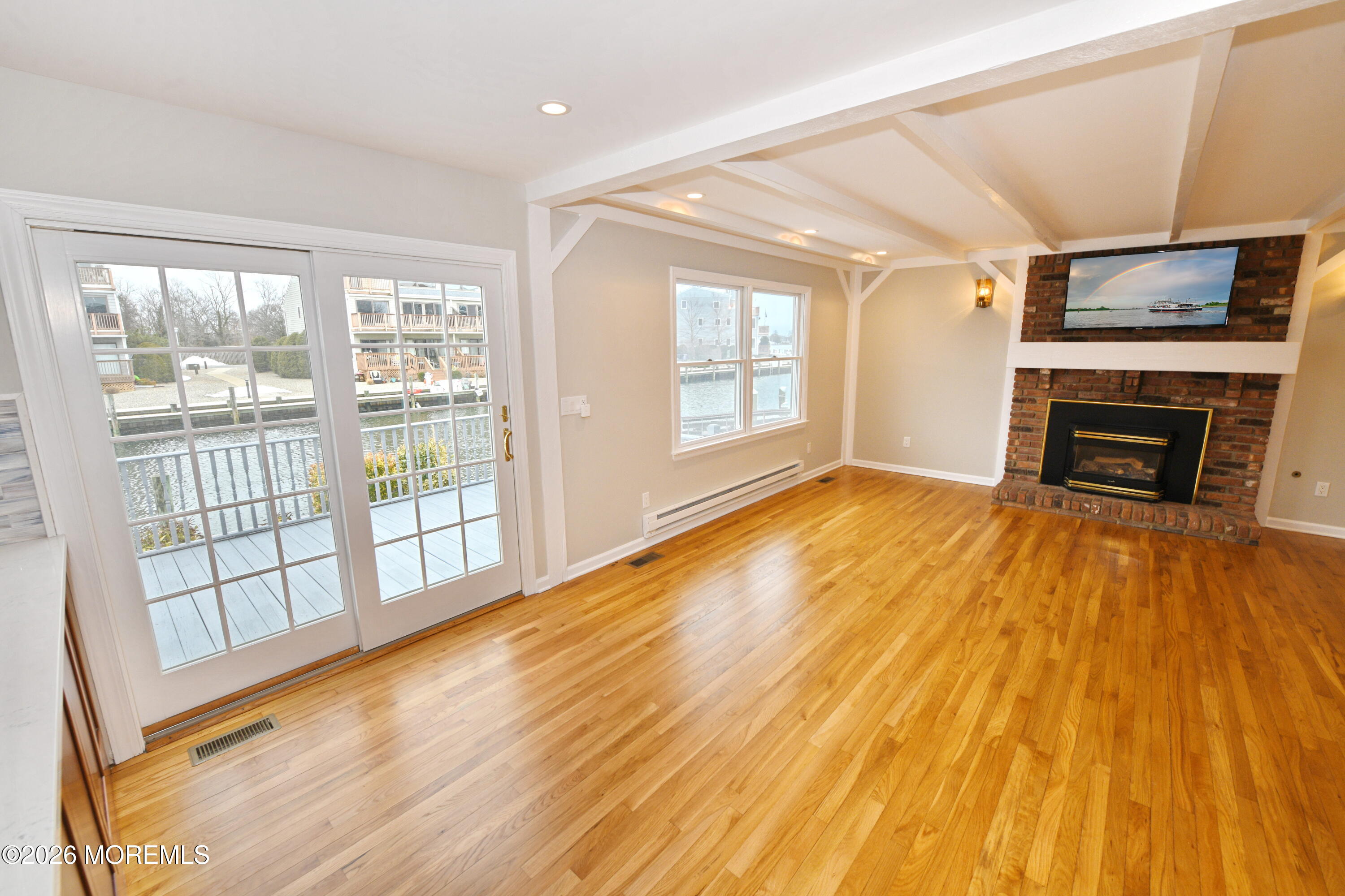 1608 Osprey Court Point Pleasant, NJ 08742 - Photo 11 of 40 a view of empty room with wooden floor and fireplace